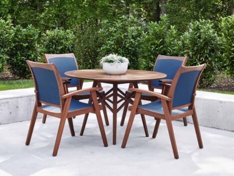 Wood table with 4 blue and wood chairs luxury outdoor living by hausers patio