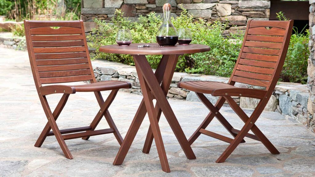 Wooden slatted chairs by small outdoor table from Hauser's Patio in San Diego, CA