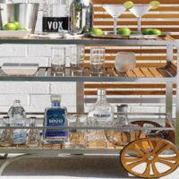 Serving cart from Hauser's Patio with various bottles of alcohol on it