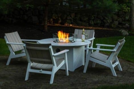 Chat chairs around round fire pit from hausers patio luxury outdoor living by hausers patio
