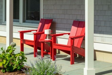 Red adirondack chairs on patio by hausers patio luxury outdoor living by hausers patio