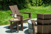 Adirondack chair by table with wine by Hauser's Patio