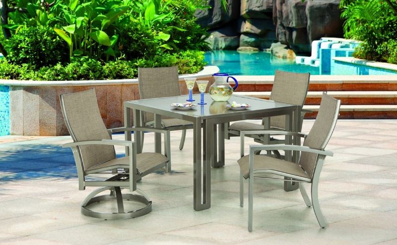 https://hauserspatio.com/wp-content/uploads/2023/11/Outdoor-table-with-taupe-chairs-by-pool-from-Hausers-Patio.jpg