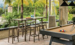 Outdoor bar height table and chairs by pool table by Hauser's Patio