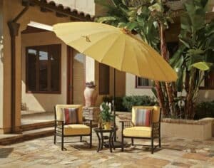 Yellow umbrella and cushioned chairs on patio from hauser luxury outdoor living by hausers patio's Patio