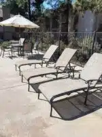Lounge chairs by metal fencing by Hauser's Patio