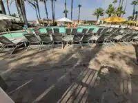 Rows of lounge chairs in front of pool by Hauser's Patio